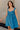 Front view of model wearing the Lucille Dark Turquoise Sleeveless Mini Dress which features dark turquoise fabric, a smocked sweatheart neckline and back, smocked thick straps, and dark turquoise lining.