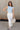 Full body view of model wearing the Oakley Light Blue Sleeveless Top which features light blue knit fabic, cropped waist, scooped neckline, thick straps and sleeveless.