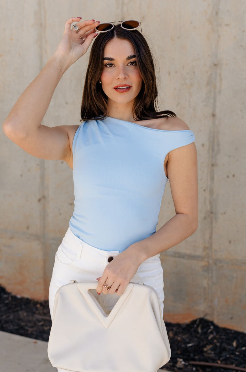 Front view of model wearing the Oakley Light Blue Sleeveless Top which features light blue knit fabic, cropped waist, scooped neckline, thick straps and sleeveless.