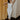 Full body view of model wearing the Camila Cream Denim Button-Up Midi Dress which features  cream denim fabric, contrast stitching, a button-up front with silver button closures, side and back pockets, a sweetheart neckline, thick straps, and a midi-length hem.