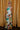 Full body view of model wearing the Alexandria Multi Abstract Halter Maxi Dress which features yellow, white, orange, green, and pink abstract print, cream full length lining, adjustable straps, a halter neckline with a tie, a low back, and a maxi length hemline.