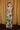 Full body back view of model wearing the Alexandria Multi Abstract Halter Maxi Dress which features yellow, white, orange, green, and pink abstract print, cream full length lining, adjustable straps, a halter neckline with a tie, a low back, and a maxi length hemline.