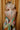 Close up back view of model wearing the Alexandria Multi Abstract Halter Maxi Dress which features yellow, white, orange, green, and pink abstract print, cream full length lining, adjustable straps, a halter neckline with a tie, a low back, and a maxi length hemline.