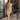 Full body front view of model wearing the brown colored Eleanor Sleeveless Button Front Mini Dress that has cotton fabric, a button-up front with silver buttons, buttoned chest pockets, a collared neckline, and a racerback cut.