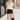 Full body front view of female model wearing the Dana Black Frayed Hem Denim Shorts that feature black distressed denim, frayed hems, and pockets. Paired with white top.