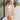 front view of model wearing the Cassidy Beige Gauze Shorts that feature beige gauze fabric, an elastic drawstring waist, side pockets, and frayed hem details.