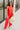 Full body front view of model wearing the Vada Red Wide Leg Pants that feature red woven fabric, side pockets, an elastic waistband, and flowy wide legs.