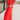 Side view of model wearing the Vada Red Wide Leg Pants that feature red woven fabric, side pockets, an elastic waistband, and flowy wide legs.