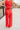 Back view of model wearing the Vada Red Wide Leg Pants that feature red woven fabric, side pockets, an elastic waistband, and flowy wide legs.