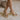 Ariel view of female model wearing the Chinese Laundry Theresa Platform Heel in Metallic which features gold metallic faux leather fabric, block heel, round toe, platform sole and adjustable strap.