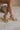 Ariel view of female model wearing the Chinese Laundry Theresa Platform Heel in Metallic which features gold metallic faux leather fabric, block heel, round toe, platform sole and adjustable strap.