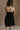 Back view of female model wearing the Abigail Strapless Flare Mini Dress in black which features features Mini Length, Lining, Two Side Pockets, Strapless and Monochrome Back Zipper with Hook Closure.