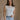 Front view of female model wearing the Elisa Cream Knit Sleeveless Tank which features Cream Cotton Fabric, Open Knit Details, Round Neckline and Sleeveless