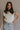 Front view of female model wearing the Vivian Ivory & Navy Knit Sleeveless Sweater which features Cream Cable Knit Fabric, Navy Trim Details, Left Front Chest Pocket, High Neckline and Sleeveless.