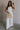 Full body view of female model wearing the Sloane White Wide Leg Pants which features  White Lightweight Fabric, Wide Leg Pants, Side Zipper with Hook Closure and White Lining