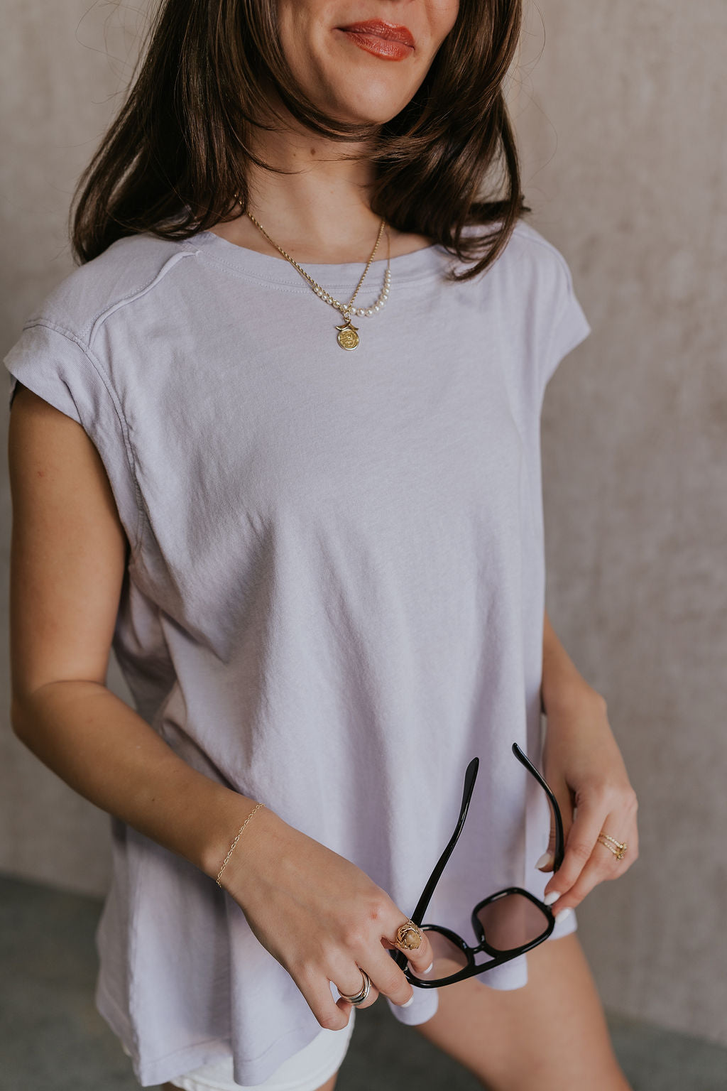 Close up side view of female model wearing the Khloe Lavender Short Sleeve Top which features Lavender Cotton Fabric, Round Neckline and Short Sleeves