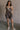 Full body view of female model wearing the Vera Washed Black Sleeveless Romper which features Washed Black Cotton Fabric, Two Side Pockets , V-Neckline, Sleeveless and Adjustable Straps