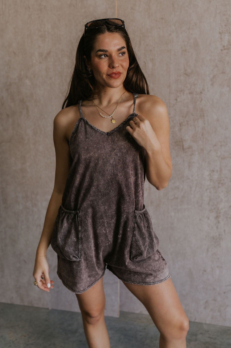 Front view of female model wearing the Vera Washed Black Sleeveless Romper which features Washed Black Cotton Fabric, Two Side Pockets , V-Neckline, Sleeveless and Adjustable Straps