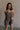 Front view of female model wearing the Vera Washed Black Sleeveless Romper which features Washed Black Cotton Fabric, Two Side Pockets , V-Neckline, Sleeveless and Adjustable Straps