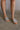 Front view of female model wearing the Baxter Sandal in Silver which features Silver Skinny Straps with Wooven Details,  Leather Upper, Padded Insole and Slip-On Style