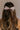 Back view of brunette model's hair; model is wearing the Amelia Sheer Hair Bow Barrette in Light Pink.