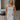 Front view of female model wearing the Emerson White Blue Floral Ruffle Mini Dress which features White Lightweight Fabric, Blue Floral Print, Ruffle Hem Design, Square Neckline and sleeveless
