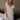 Front view of female model wearing the Rhea White Floral Ruffle Mini Dress which features Off White Lightweight Fabric, Mini Babydoll Style, Off White Lining, Monochrome Floral Print with Silver Metallic Thread, Sweetheart Neckline, Ruffle Straps and Open Back with Tie Closure