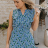 Front view of female model wearing the June Blue & Green Floral Ruffle Mini Dress which features Blue and Green Floral Print, Ruffle Tiered Design, Mini Length, High Neck with V-Cutout and Sleeveless
