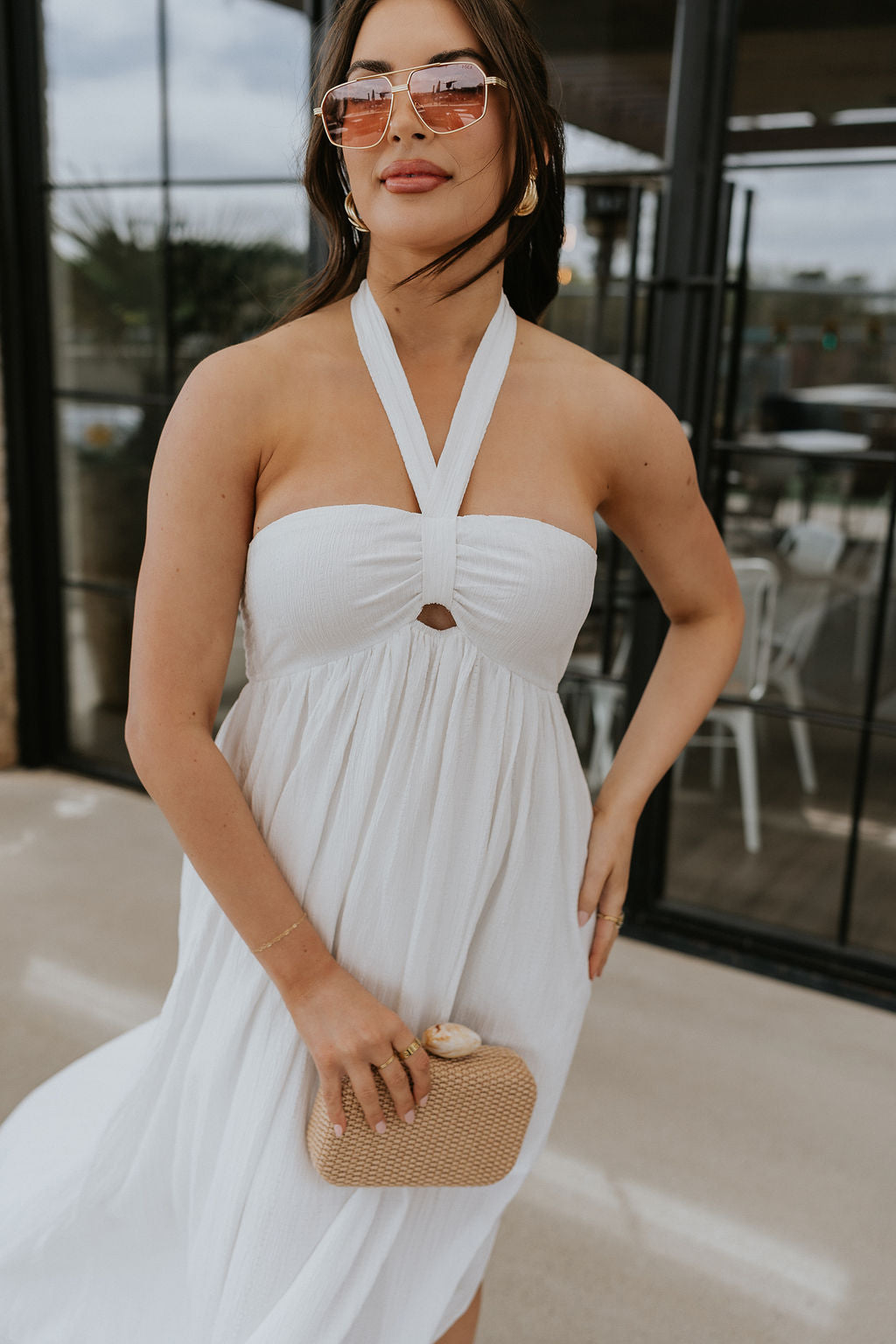 Front view of female model wearing the Lina Off White Halter Neckline Maxi Dress which features White Lightweight Fabric, White Lining, Maxi Length, Slit Detail, Halter Tie Neckline with Key Hole Detail and Elastic Back