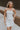 Front view of female model wearing the Blaire Off White Rhinestone Strapless Mini Dress which features Lightweight White Fabric, Mini Length, White Lining, Strapless, Rhinestone Upper Hem Detail and Monochrome Back Zipper with Hook Closure