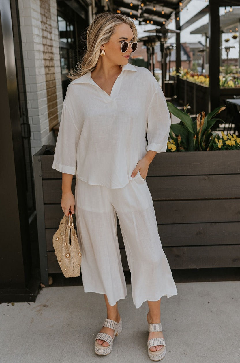 Full body view of female model wearing the Rebecca Ivory Linen Top which features vory Linen Fabric, Half Sleeves and Collared Neckline with V-Cutout