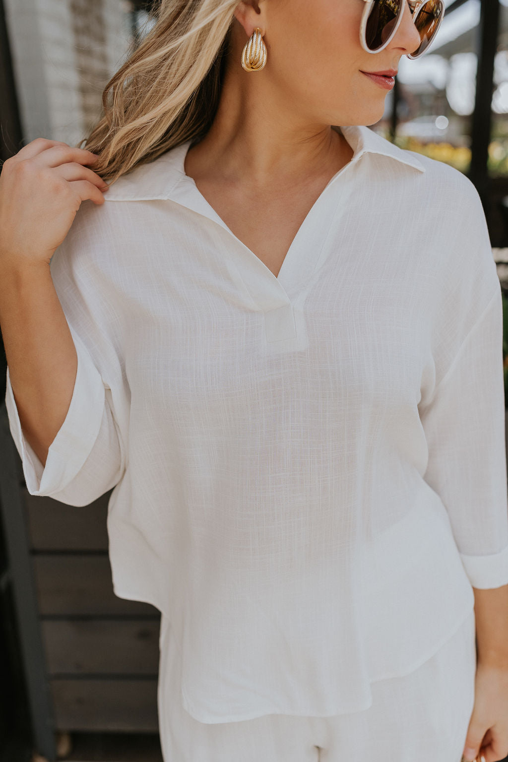 Close up view of female model wearing the Rebecca Ivory Linen Top which features vory Linen Fabric, Half Sleeves and Collared Neckline with V-Cutout