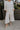 Front view of female model wearing the Rebecca Ivory Linen Cropped Pants which features Ivory Linen Fabric, Cropped Pant Legs, Ivory Lining, Two Side Pockets and Elastic Waistband