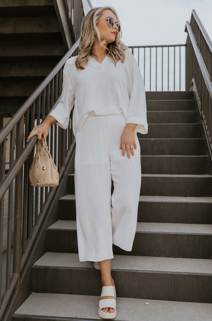 Full body view of female model wearing the Rebecca Ivory Linen Cropped Pants which features  Ivory Linen Fabric, Cropped Pant Legs, Ivory Lining, Two Side Pockets and Elastic Waistband