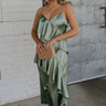 Full body view of female model wearing the Azalea Dark Sage Satin Ruffle Midi Dress which features Green satin fabric Diagonal ruffles down the bust and waist, Spaghetti straps, V-Neckline, Elastic across the back top and Midi length