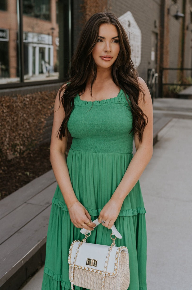 Front view of female model wearing the Selah Green Smocked Midi Dress which features Green Lightweight Fabric, Ruffle Tiered Body, Green Lining, Midi Length, Smocked Upper, Square Neckline and Thick Straps