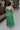 Full body back view of female model wearing the Selah Green Smocked Midi Dress which features Green Lightweight Fabric, Ruffle Tiered Body, Green Lining, Midi Length, Smocked Upper, Square Neckline and Thick Straps