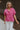 Front view of female model wearing the Everlee Pink Short Sleeve Top which features Pink Lightweight Fabric, Short Sleeves with Pearlescent Buttoned Cuffs and Collar Neckline with V-Cutout