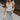 Full body view of female model wearing the Lauren White Ruffle Plunge Neckline Tank which features White Lightweight Fabric, Peplum Hem Body, Sweetheart Neckline, Ruffle Straps, Open Back Corset Tie  and  Back Zipper with Hook Closure