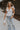 Full body view of female model wearing the Lauren White Ruffle Plunge Neckline Tank which features White Lightweight Fabric, Peplum Hem Body, Sweetheart Neckline, Ruffle Straps, Open Back Corset Tie  and  Back Zipper with Hook Closure
