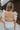 Back view of female model wearing the Lauren White Ruffle Plunge Neckline Tank which features White Lightweight Fabric, Peplum Hem Body, Sweetheart Neckline, Ruffle Straps, Open Back Corset Tie and Back Zipper with Hook Closure
