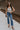 Full body view of female model wearing the Elaina Black & Cream Floral Tank which features Black and Cream Floral Smocked Fabric, Cropped Waist, Lettuce Hem Details, Square Neckline and Thick Straps