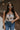 Front view of female model wearing the Elaina Black & Cream Floral Tank which features Black and Cream Floral Smocked Fabric, Cropped Waist, Lettuce Hem Details, Square Neckline and Thick Straps