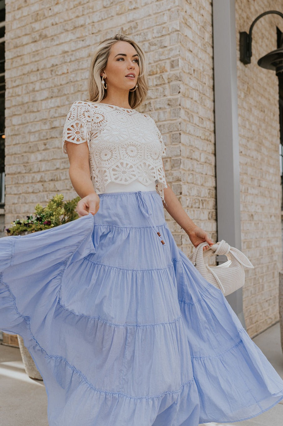 Full body view of female model wearing the Alana Periwinkle Tiered Maxi Skirt  which features Periwinkle Lightweight Fabric, Maxi Length, Periwinkle Thigh Length Lining, Tiered Body and Elastic Waistband with Drawstring Ties