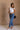 Full body front view of model wearing the Oakley White Sleeveless Top which features light blue knit fabic, cropped waist, scooped neckline, thick straps and sleeveless.
