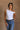 Front view of model wearing the Oakley White Sleeveless Top which features light blue knit fabic, cropped waist, scooped neckline, thick straps and sleeveless.