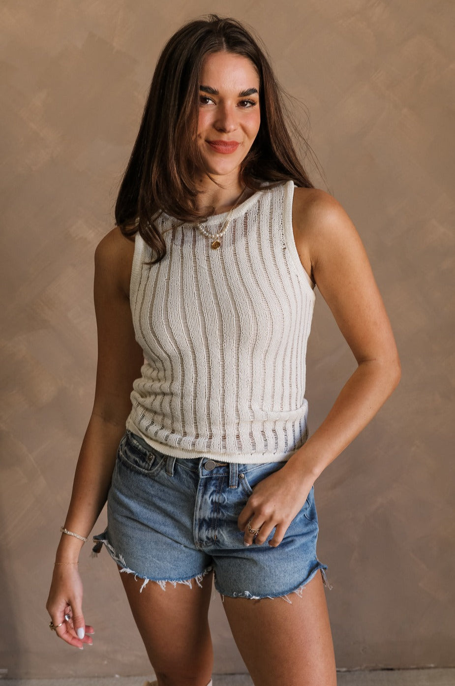 Front view of female model wearing the Bria Cream Knit Sleeveless Tank which features Cream Knit Fabric, Round Neckline and Sleeveless