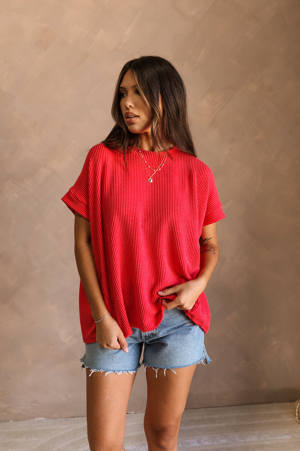Full body front view of model wearing the Destiny Ribbed Short Sleeve Top in Red which features Ribbed Fabric, Round Neckline and Short Sleeves.