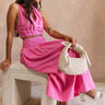 Full body view of female model wearing the Valery Pink Tiered Midi Skirt which features Pink Cotton Fabric, Pink Lining, Upper Pleated Details and Smocked Waistband