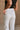 Close up back view of female model wearing the Cienna Cream Cropped Wide Leg Pants which features White Cotton Slight Stretch Fabric, Cropped Wide Pant Legs, Thick Hem Detail, Two Front Pockets, Two Back Pockets, Front Zipper with Double Button Closure and Belt Loops